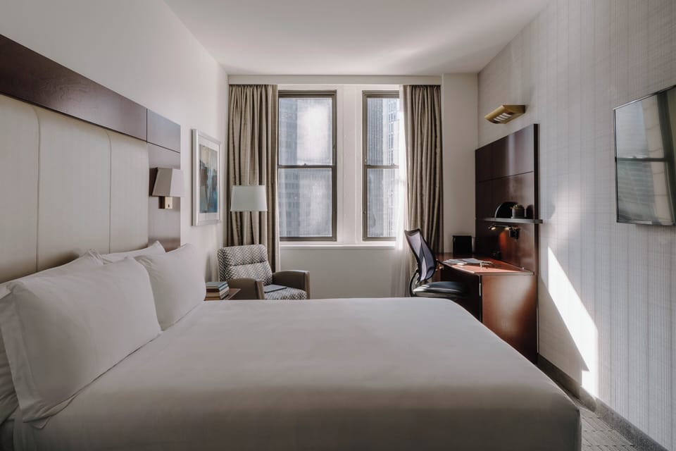 Premium bedding, desk, laptop workspace, blackout drapes