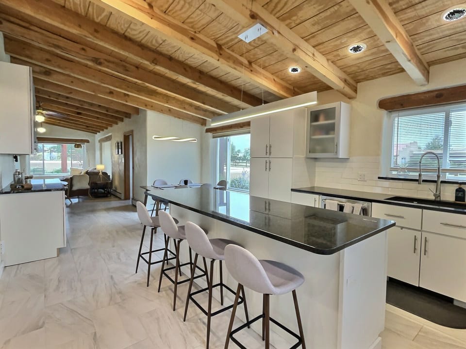 Kitchen bar island for social time mixed with meal prep, and tasty apps.