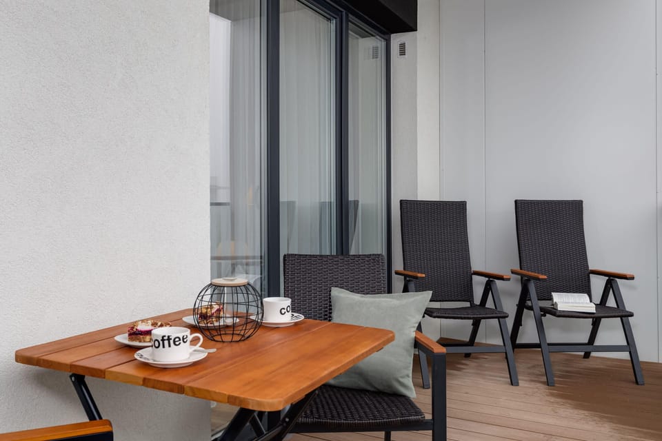 A cozy balcony setup with wooden furniture and a relaxing vibe.
