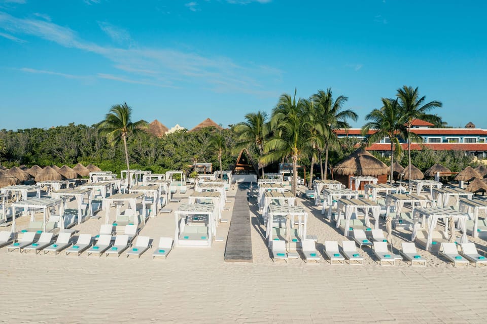On the beach, white sand, sun loungers, beach umbrellas