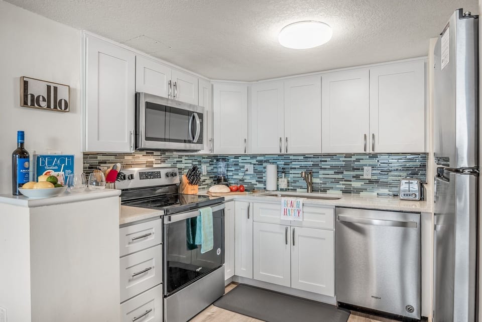 Your fully equipped kitchen makes meal prep a breeze with gleaming stainless appliances and stylish mosaic backsplash.