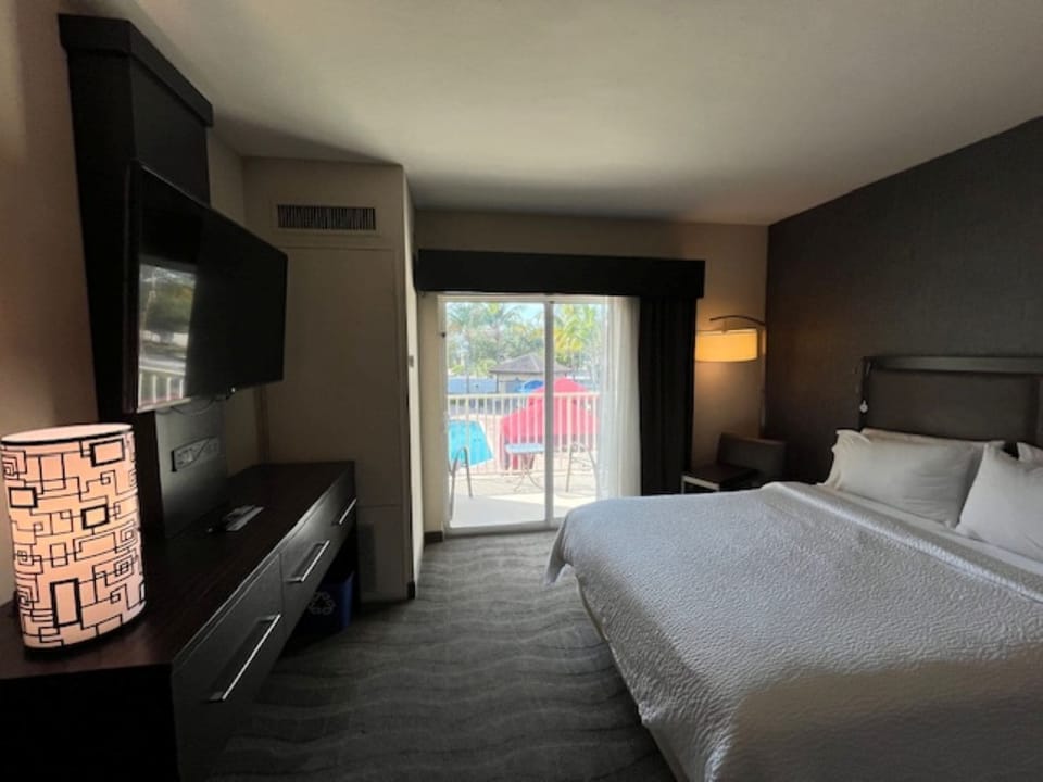 Premium bedding, desk, laptop workspace, blackout drapes