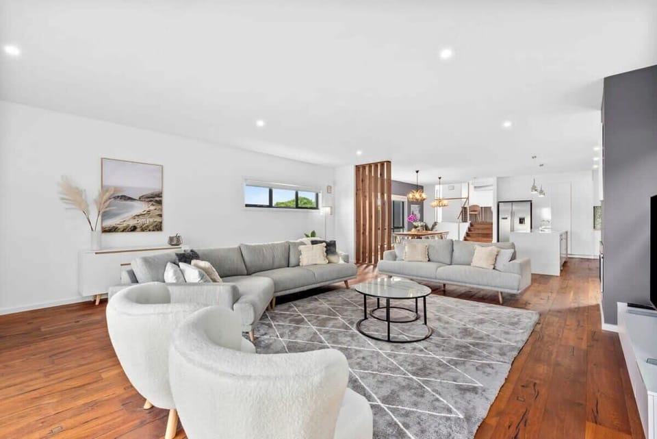 The lower level features a spacious living area with coastal luxe furnishings