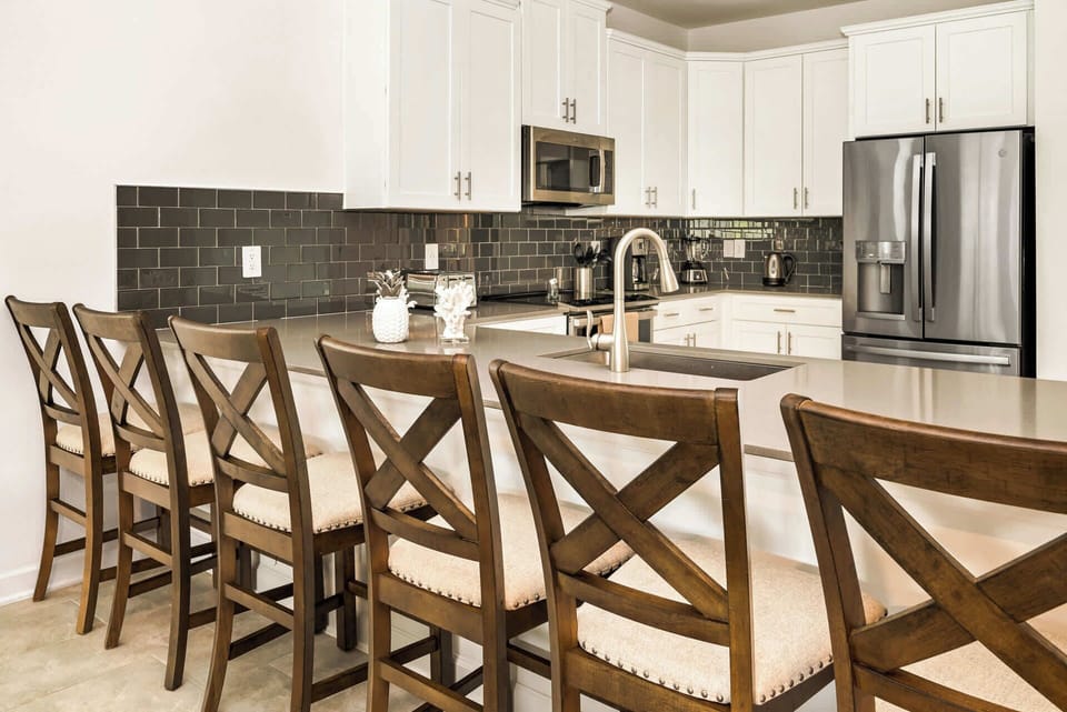 Spacious kitchen with modern amenities and ample seating, perfect for family gatherings and culinary adventures.