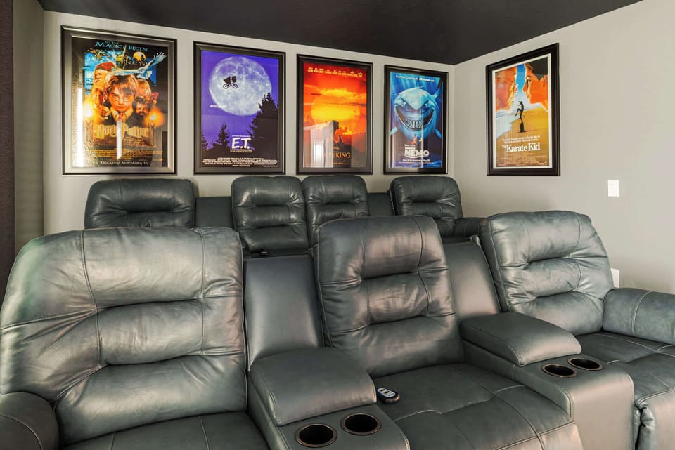 Enjoy movie nights in your private home theater with luxurious seating and iconic film posters.
