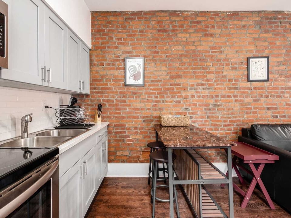 Kitchen has seating for dining and work.
