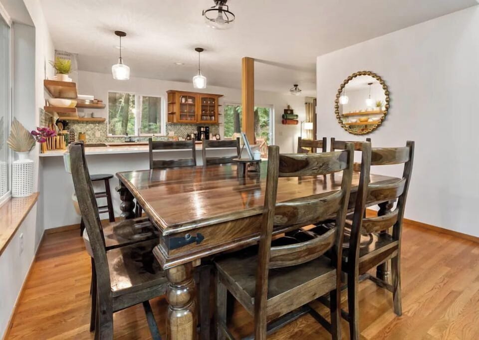 A beautiful rose wood table that can seat 8 with 4 bar stools by peninsula