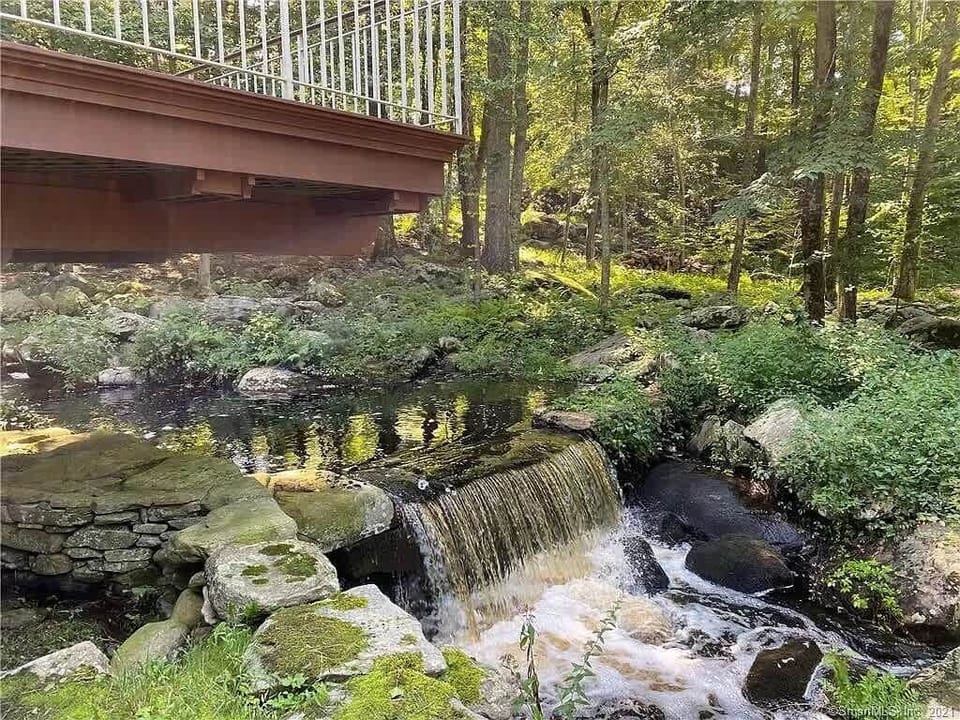 A natural waterfall flows through the property