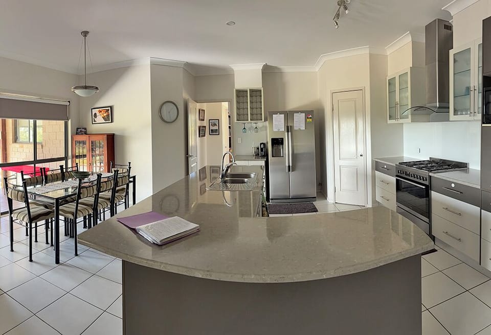 Open plan kitchen/dining with large walk in pantry with appliances.