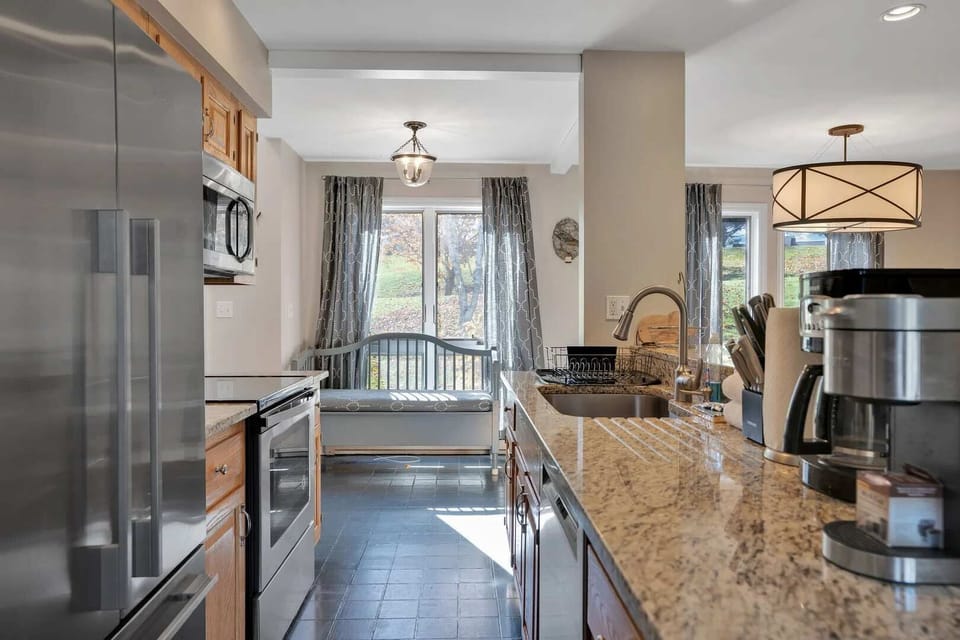 Full kitchen with refrigerator, oven, microwave, coffee maker, and knife block