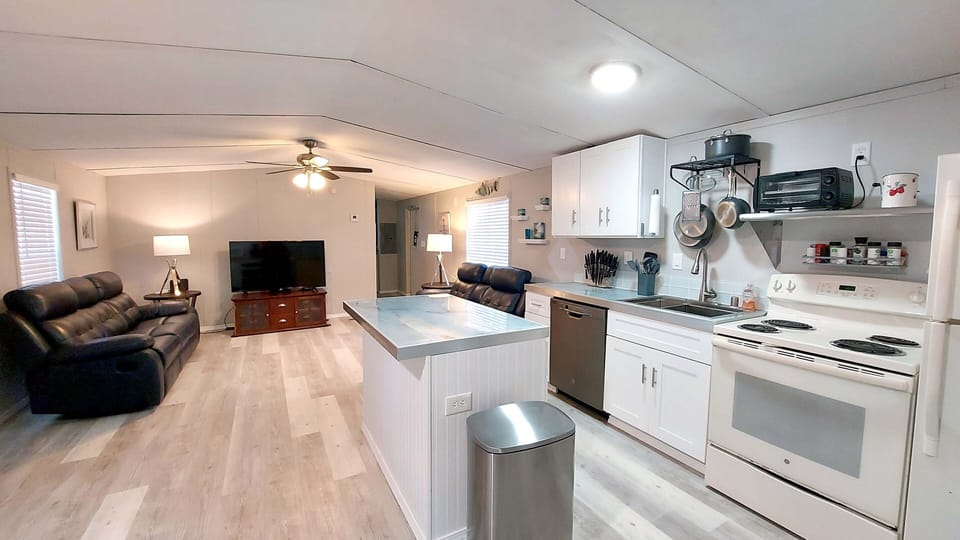 Living kitchen with Leather reclining sofa & love seat, Android TV, ceiling fan
