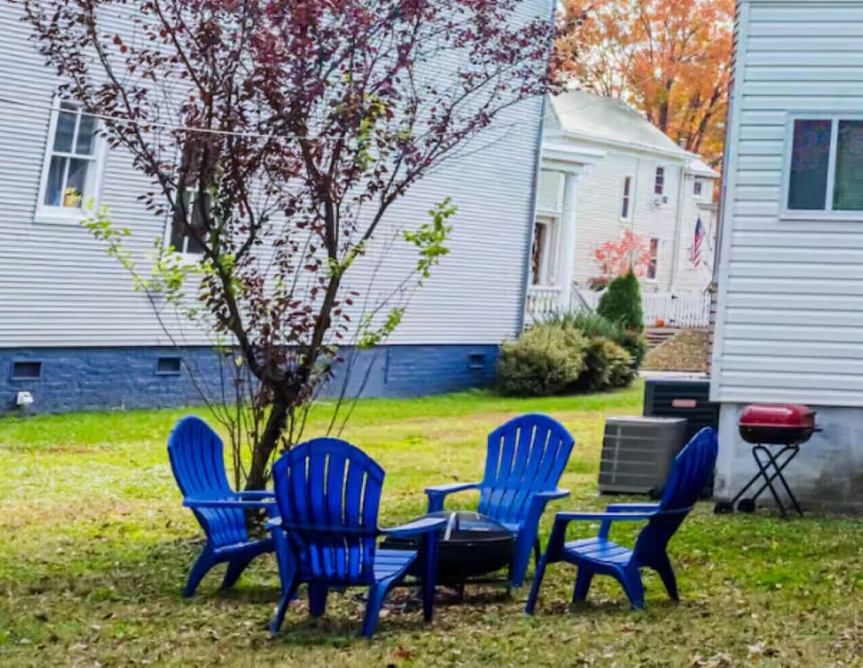 A charming backyard with outdoor seating and a fire pit, ideal for evenings under the stars.