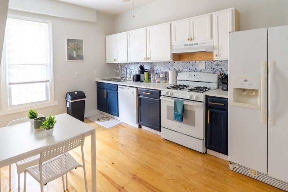 Fully stocked kitchen featuring a double-basin sink, oven range, stove, and a coffee station with Keurig and drip coffee maker combo., plus additional seating for 2!