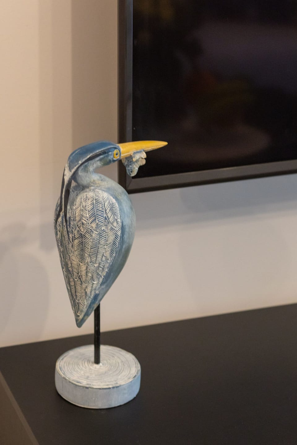 A close-up of an elegant sculpture of a bird with intricate details.
