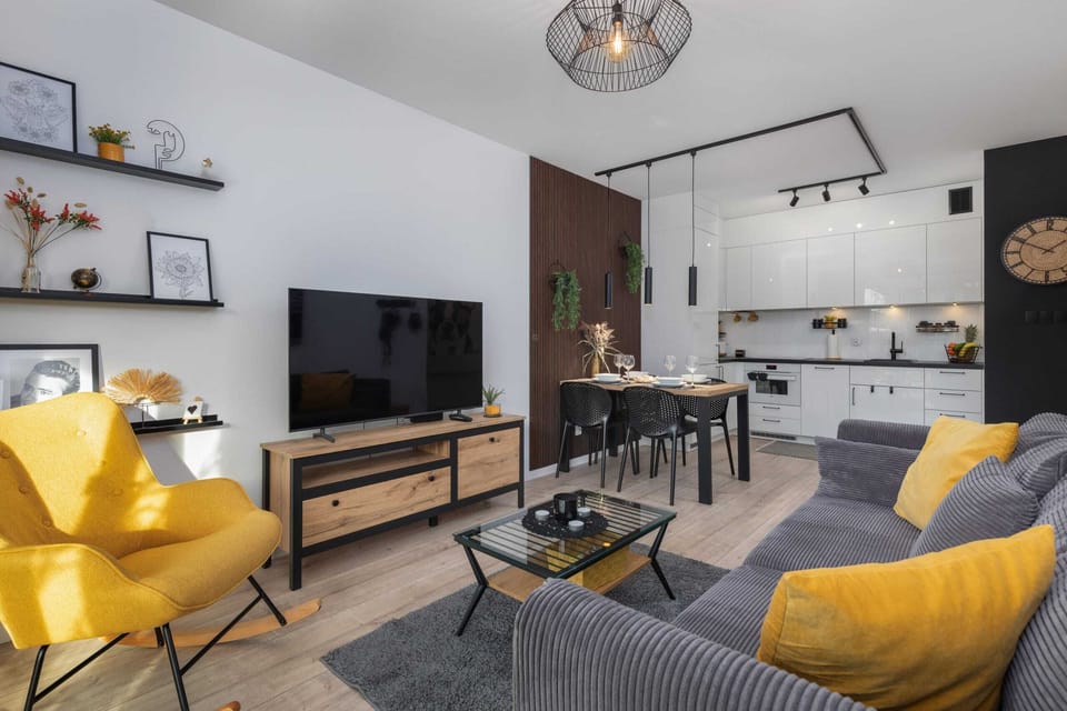 A living room with yellow accents and an open layout.
