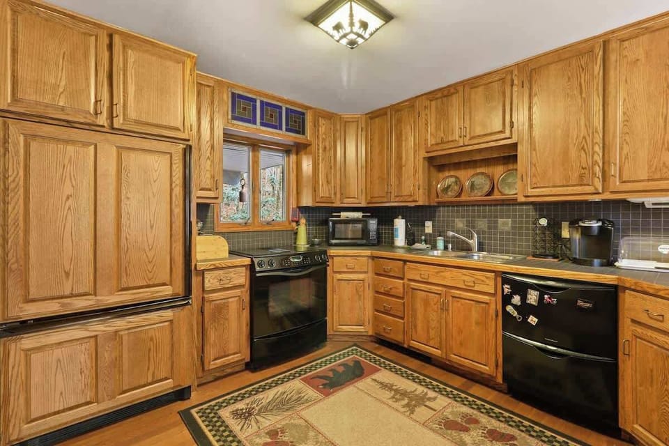 Experience a culinary sanctuary with a view in our well-stocked kitchen, where cooking harmonizes with serenity amidst breathtaking landscapes framed by windows