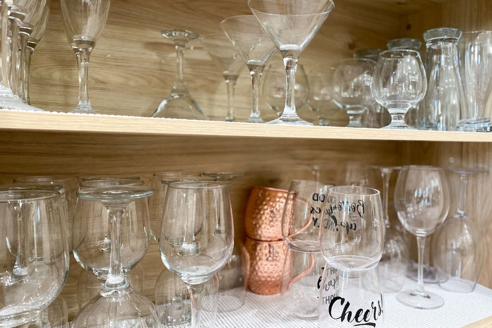Fully Stocked Bar Cabinet with cocktail shaker and glassware