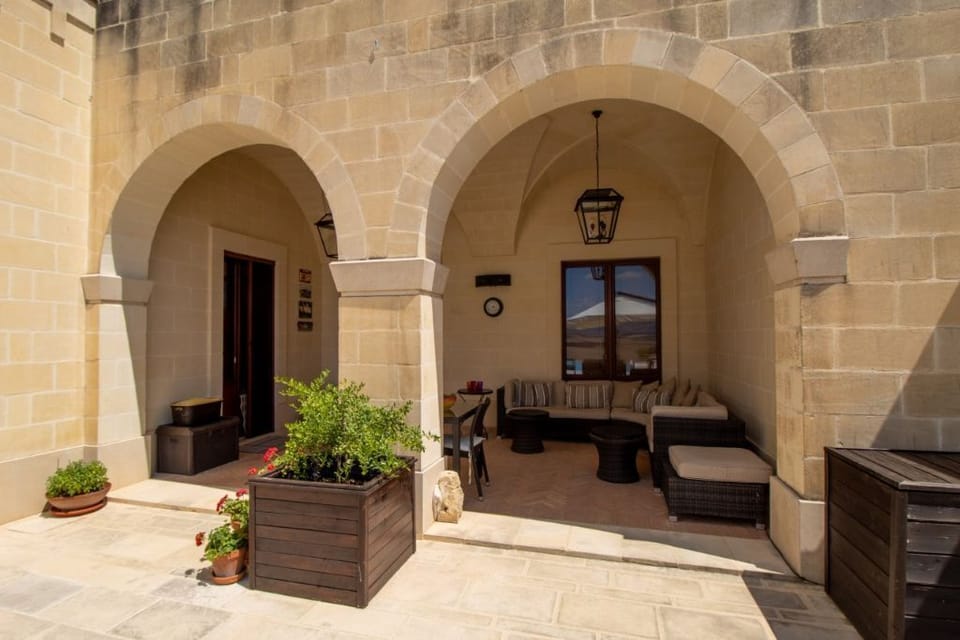 Outdoor dining are with vaulted ceilings and pool views.