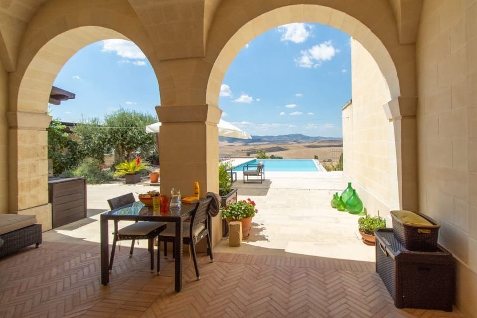 Outdoor dining are with vaulted ceilings and pool views.