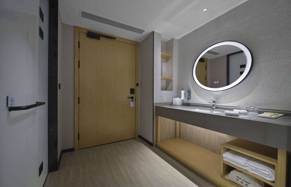Designer toiletries, hair dryer, slippers, towels