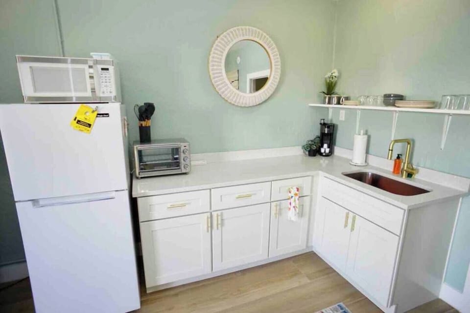 Kitchen with full refrigerator, toaster oven, microwave, 2 burner cooktop, drip coffee maker, all cooking utensils and cookware.