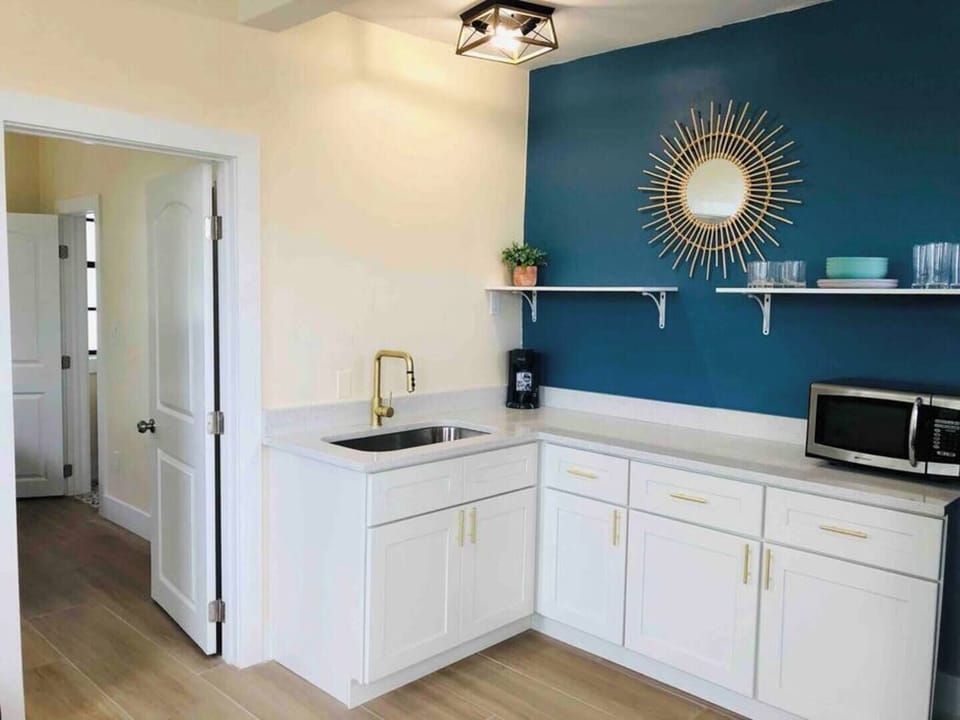 Fully stocked kitchen with toaster oven, microwave, 2 burner cooktop, and all cooking utensils and silverware.
