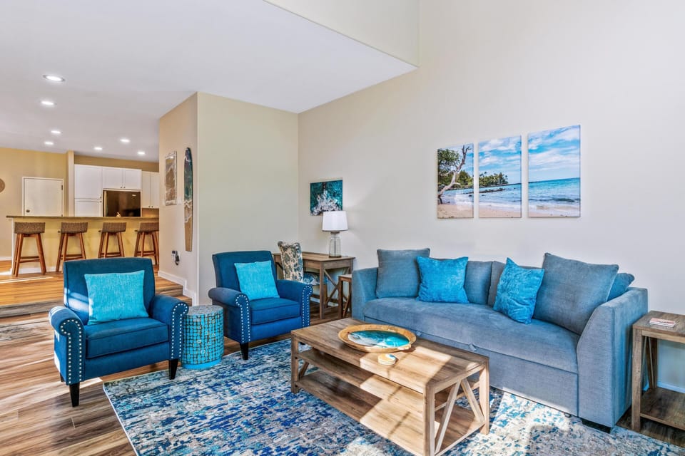 Spacious, bright living room with vaulted ceilings and tall windows