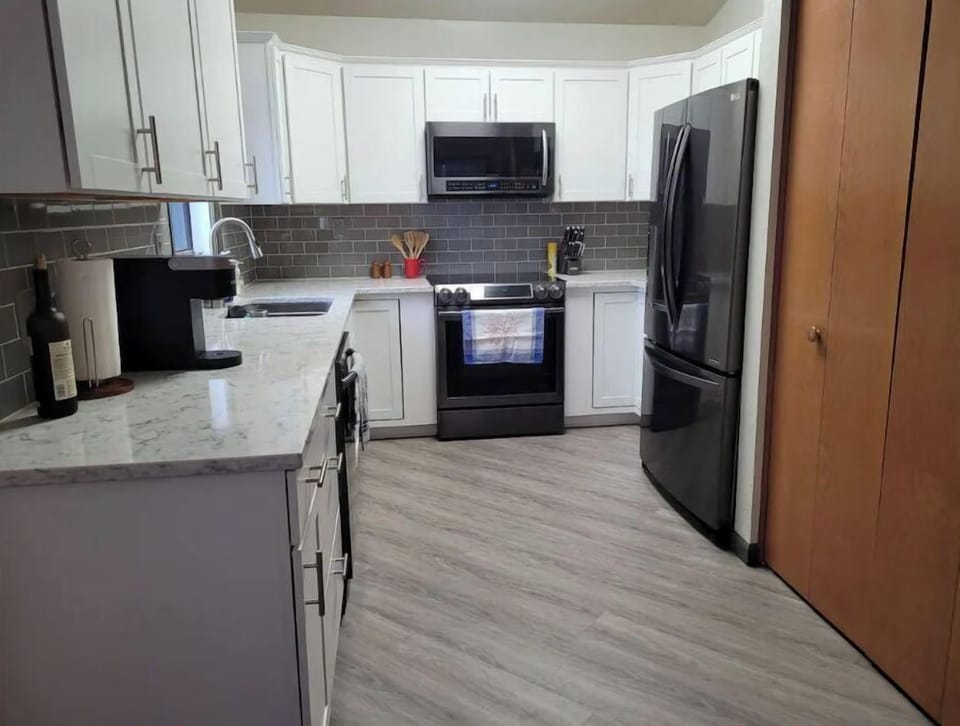 Kitchen equipped with appliances and utensils.