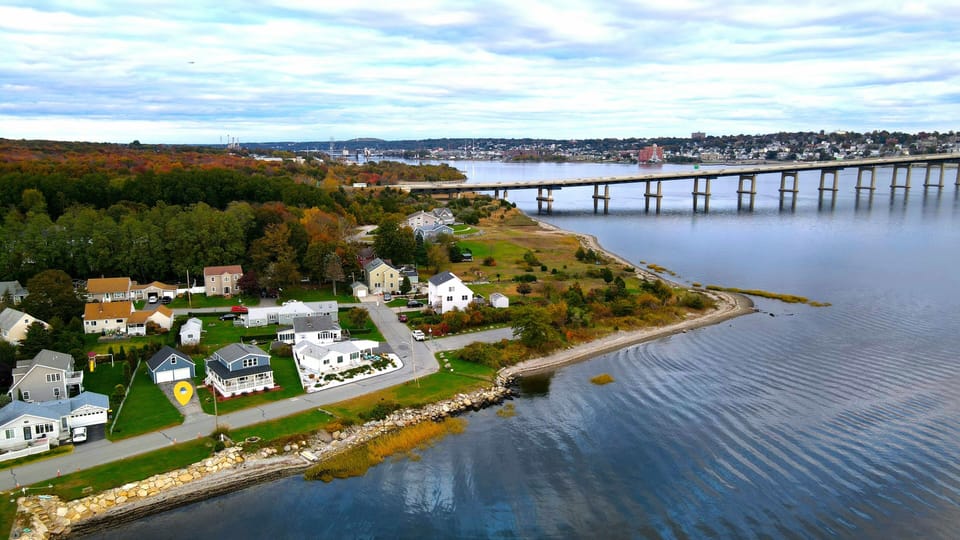 Sky view of the home & neighborhood in early fall. Braga Bridge in the distance