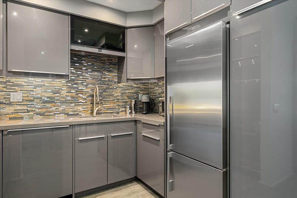 Abundant cabinetry as well as pull-out pantry. Nespresso machine & coffee maker.