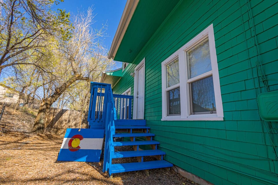 Access the upstairs unit via the north-facing blue porch