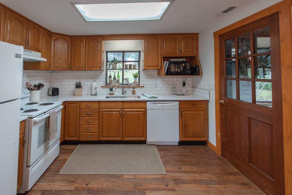 Full kitchen includes a microwave, dishwasher, toaster, oven/stove and fridge.