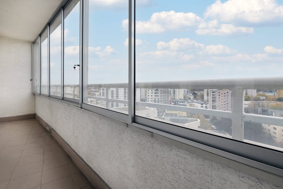 A panoramic balcony view overlooking a city skyline.
