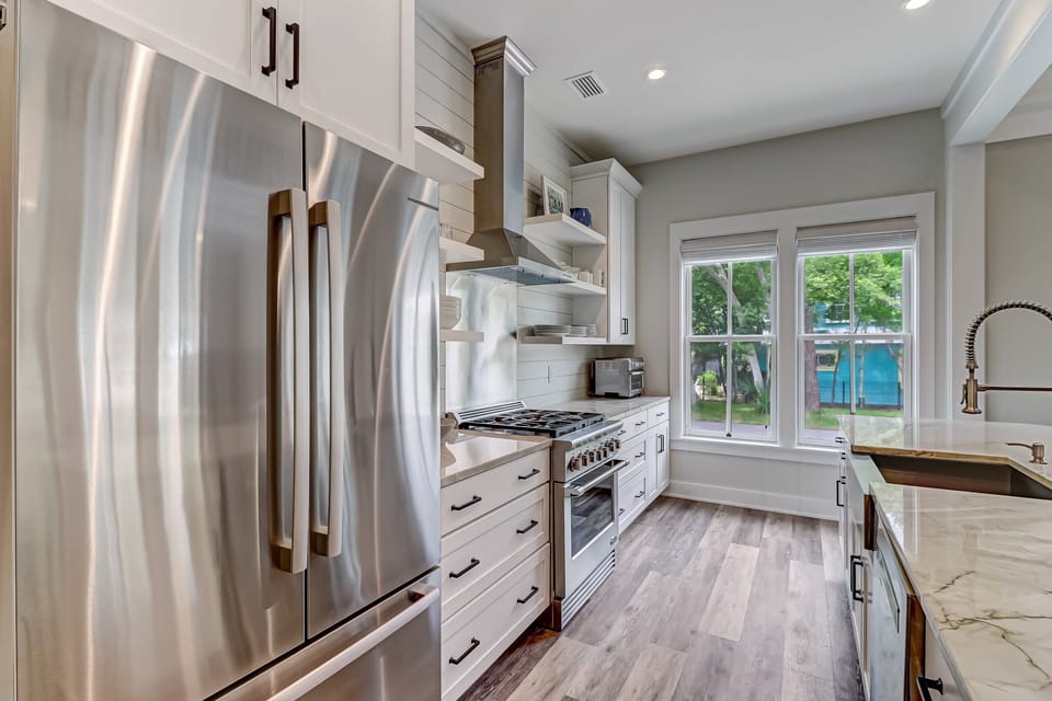 Fully Equipped Gourmet Kitchen with Granite Countertops and Stainless Appliances including a Gas Range