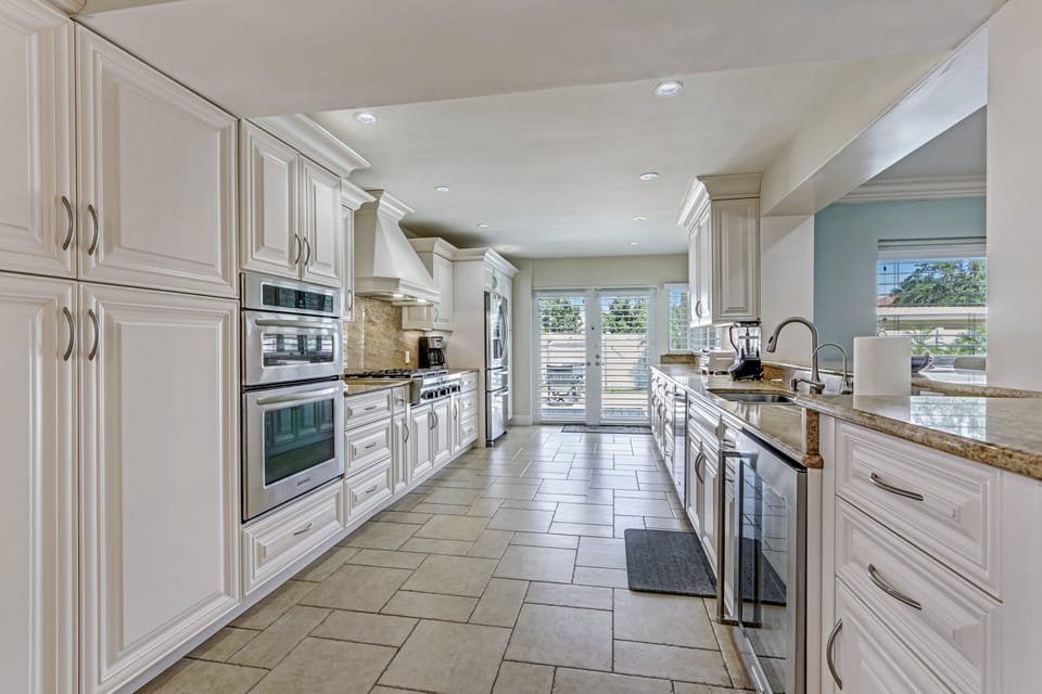 Top-of-the-line kitchen appliances include a built in microwave oven