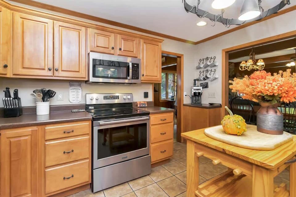 The kitchen is well stocked with cookware, knives, utensils, and dishes