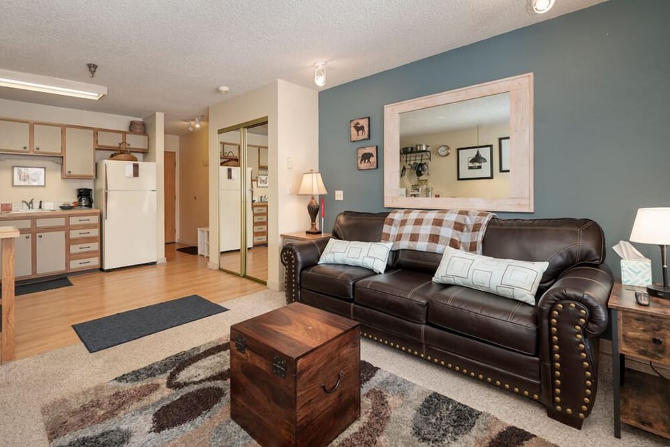 Sink into the rich leather sofa and unwind in your spacious living area, complete with full kitchen and cozy rustic touches.
