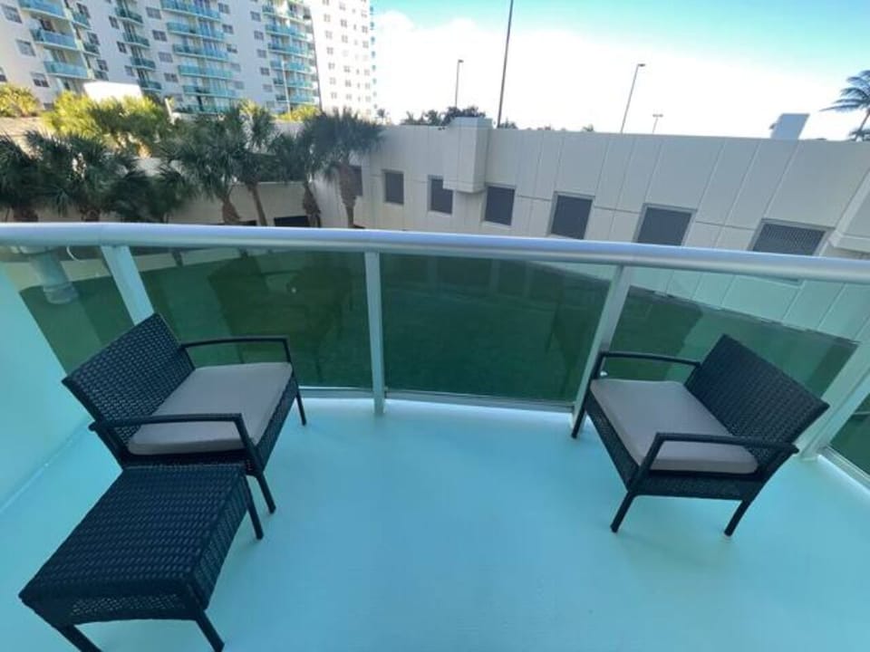 Seating for two with the palm trees swaying the in background on our patio