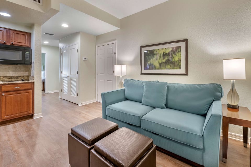 1 BEDROOM 1 QUEEN SUITE | Living area | 52-inch TV with cable channels, DVD player, table tennis