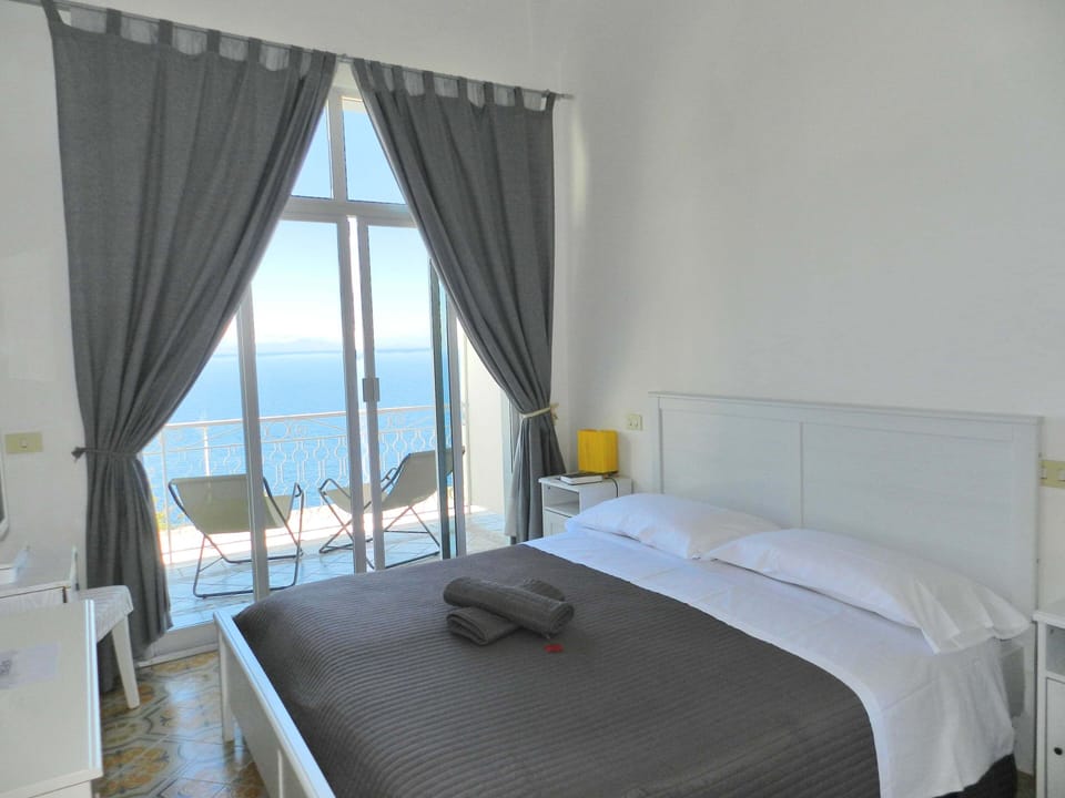 Standard Double Room, Balcony, Sea View | Minibar, in-room safe, individually decorated, desk