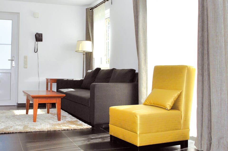 Standard Apartment | Living area | 32-inch flat-screen TV with digital channels, TV, toys