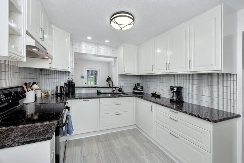 Beautifully remodeled kitchen with black granite counters