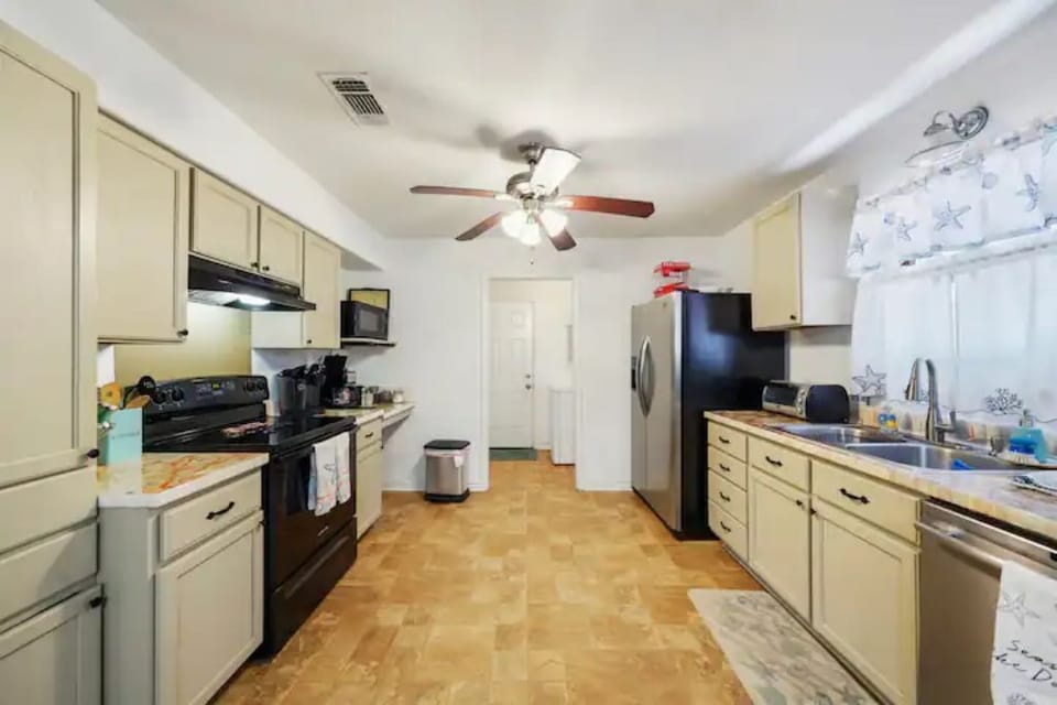 Kitchen looking towards the back boor/washroom. 