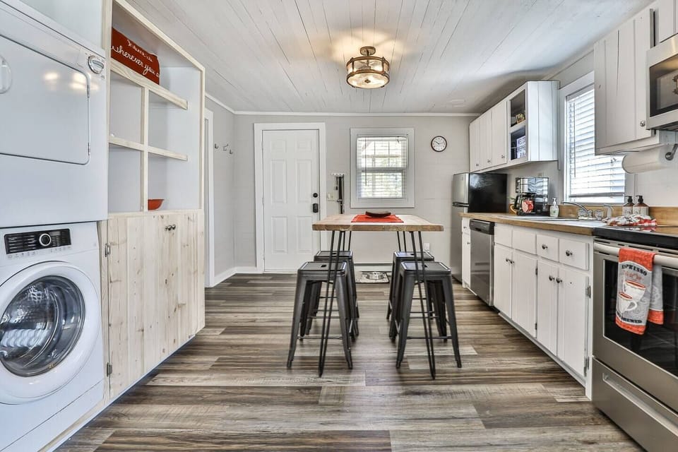 Open and airy floor plan with lots of natural light and dining table.