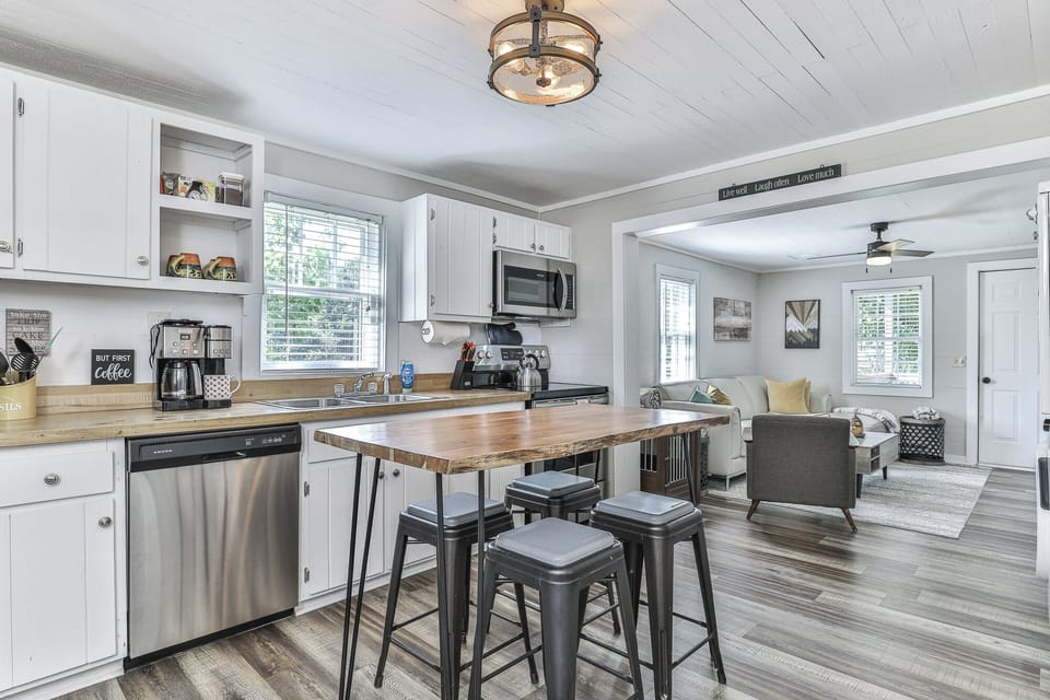 Step inside and feel at home — the kitchen with a butcher block table ready for meals (and maybe a sneaky pup snack), and the living room with a comfy leather sofa perfect for curling up with your furry friend.