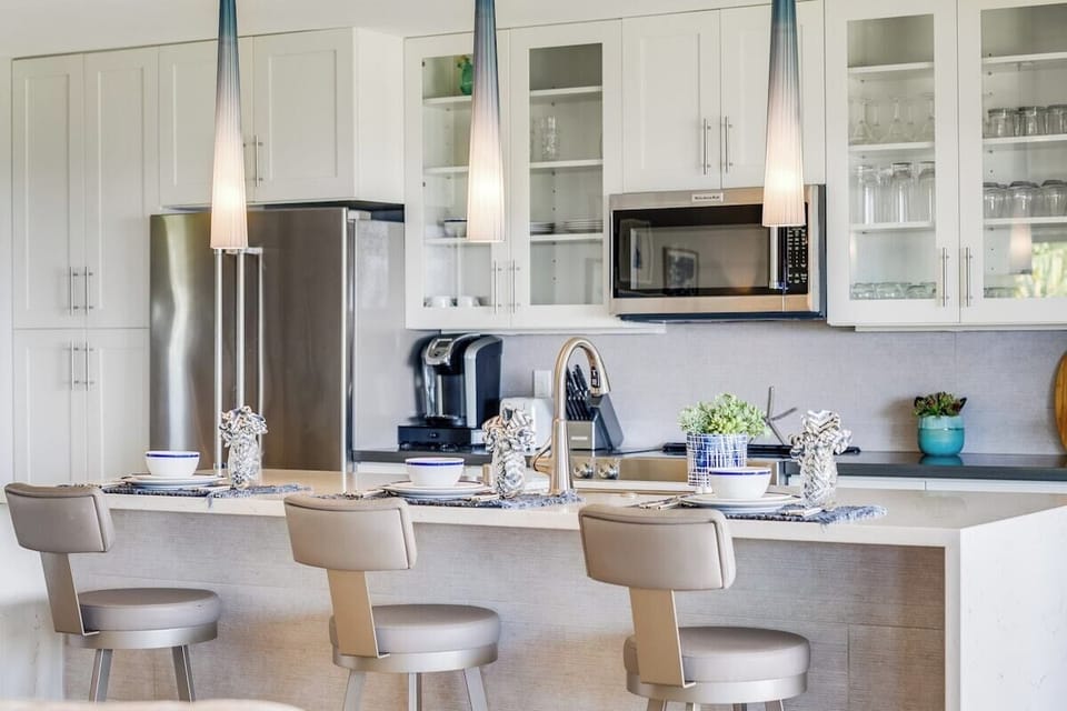 Kitchen island has padded swivel seating for three
