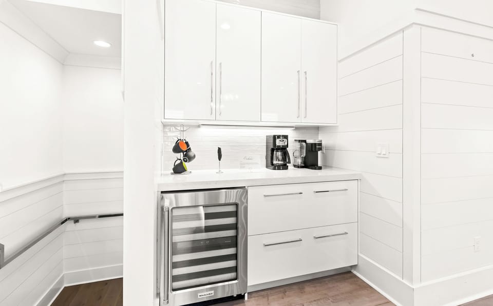 The coffee bar and beverage fridge near the kitchen