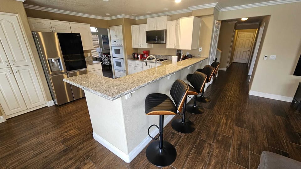 Spacious Kitchen, plenty of dishes and cookware, some spices. 