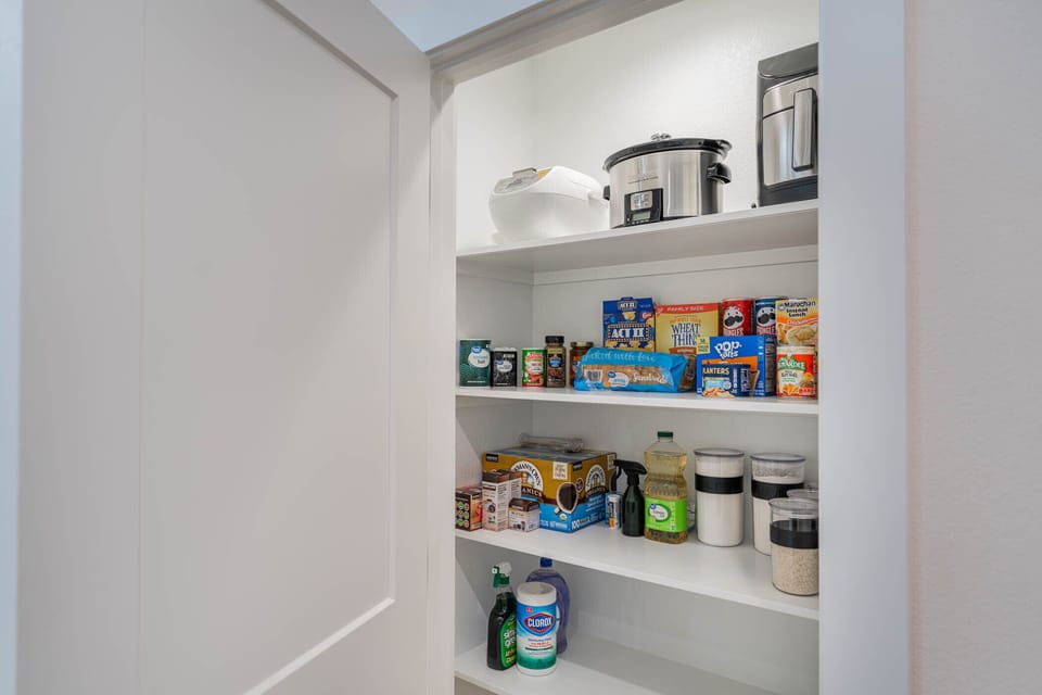 pantry stocked with basic spices, cooking ingredients (condiments in fridge)
