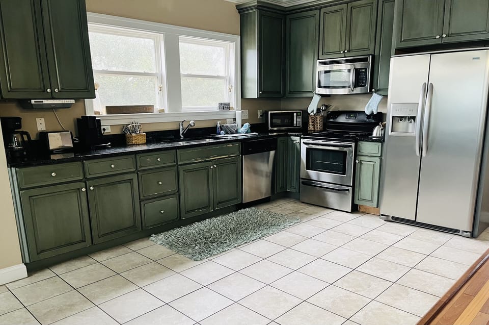 Fully stocked kitchen with Keurig, coffee pot, toaster, teapot,